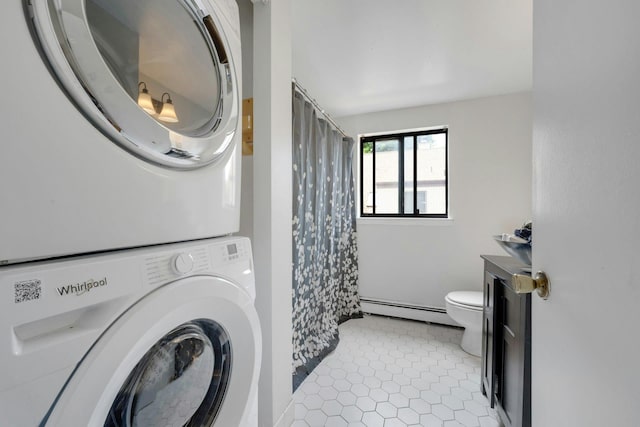 50 Dekalb Ave Unit S10, White Plains, NY 10605 - laundry area featuring stacked washer / dryer, baseboard heating, and light tile patterned floors