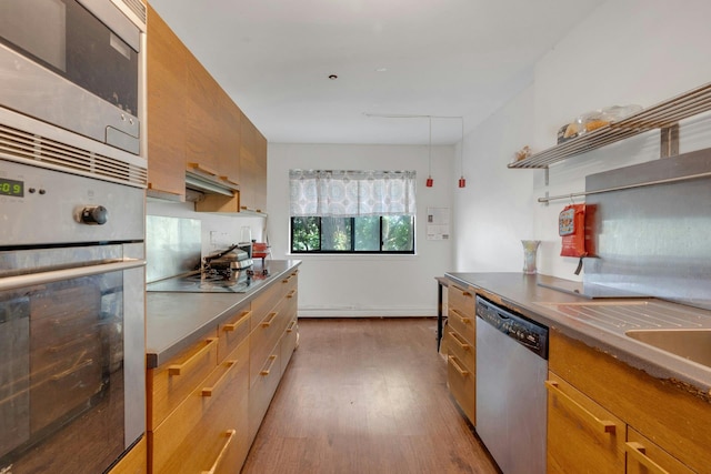 50 Dekalb Ave Unit S10, White Plains, NY 10605 - kitchen with stainless steel appliances, dark wood finished floors, stainless steel counters, and brown cabinetry