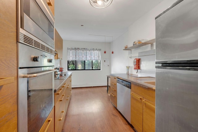 50 Dekalb Ave Unit S10, White Plains, NY 10605 - kitchen featuring stainless steel appliances, wood finished floors, open shelves, and light countertops