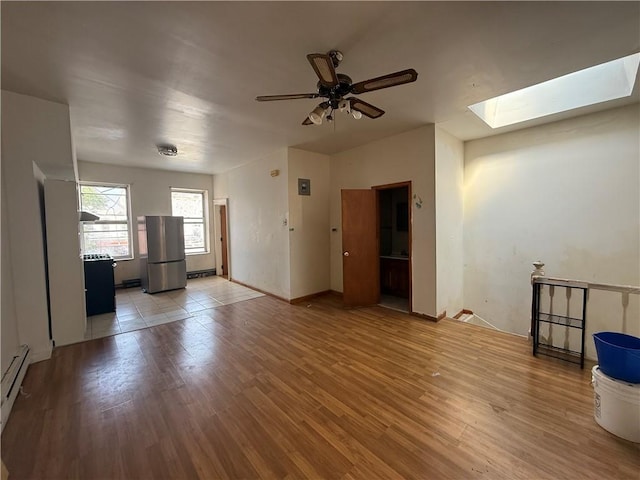 1363 64th St, Brooklyn, NY 11219 - unfurnished living room featuring a skylight, light wood finished floors, and a ceiling fan