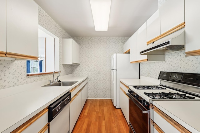 162 Deer Ct Dr, Middletown, NY 10940 - kitchen featuring white appliances, under cabinet range hood, light wood finished floors, wallpapered walls, and light countertops