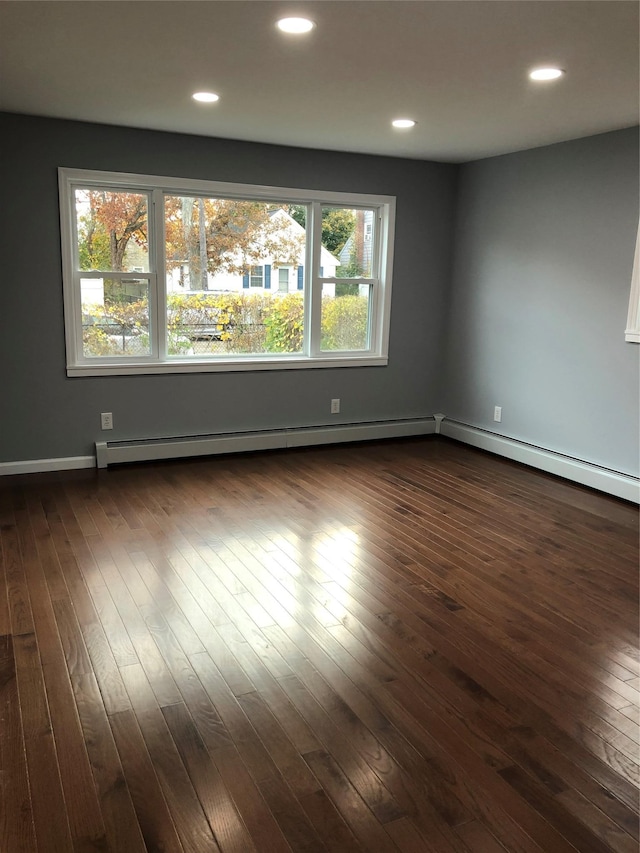 129 43rd St, Copiague, NY 11726 - unfurnished room with baseboard heating, recessed lighting, and dark wood-style floors