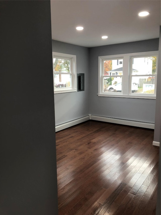 129 43rd St, Copiague, NY 11726 - unfurnished room featuring a baseboard radiator, dark wood-style flooring, and recessed lighting
