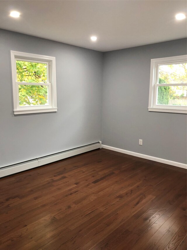 129 43rd St, Copiague, NY 11726 - unfurnished room with a baseboard heating unit, dark wood finished floors, and recessed lighting