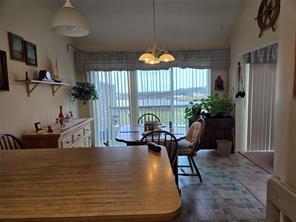 56 Pameeches Path, East Moriches, NY 11940 - dining area with a chandelier