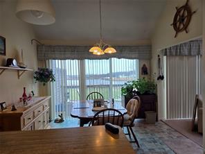 56 Pameeches Path, East Moriches, NY 11940 - dining space featuring healthy amount of natural light and a chandelier