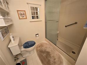 56 Pameeches Path, East Moriches, NY 11940 - bathroom featuring a shower with shower door and toilet