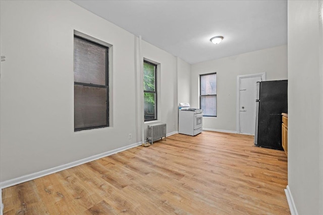 176 W 81st St Unit 3E, New York Manhattan, NY 10024 - empty room with radiator and light wood-style flooring