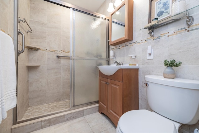 522 Shore Rd Unit 6C, Long Beach, NY 11561 - bathroom featuring vanity, a shower stall, tile patterned floors, and tile walls
