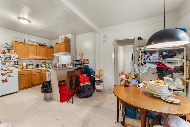 156 Beech St, Yonkers, NY 10701 - kitchen featuring freestanding refrigerator, light countertops, under cabinet range hood, brown cabinets, and light flooring