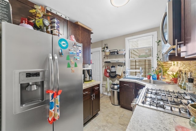 156 Beech St, Yonkers, NY 10701 - kitchen featuring appliances with stainless steel finishes, light countertops, dark brown cabinets, and decorative backsplash