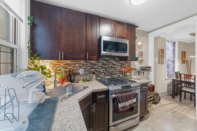 156 Beech St, Yonkers, NY 10701 - kitchen featuring stainless steel appliances, light countertops, decorative backsplash, and dark brown cabinets
