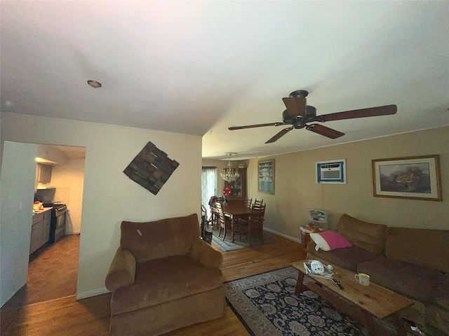 16 Drake Rd, Centereach, NY 11720 - living room featuring wood finished floors, ceiling fan, and a chandelier