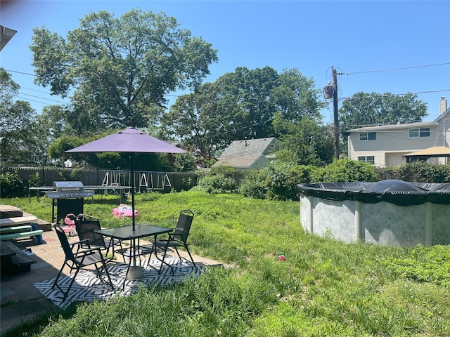 16 Drake Rd, Centereach, NY 11720 - view of yard featuring a patio area, outdoor dining area, and a covered pool