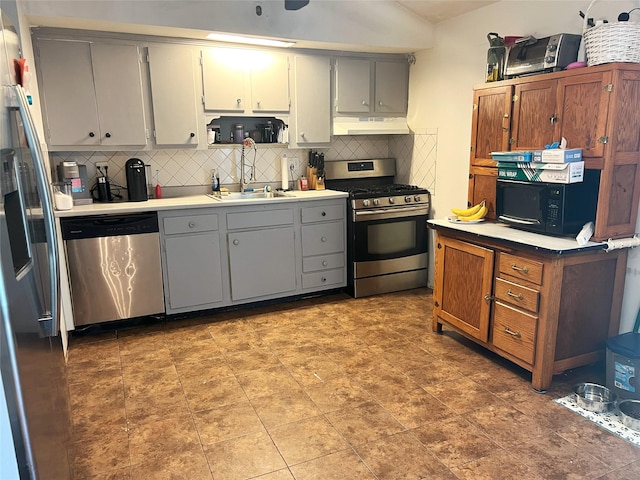 16 Drake Rd, Centereach, NY 11720 - kitchen with appliances with stainless steel finishes, under cabinet range hood, decorative backsplash, and light countertops