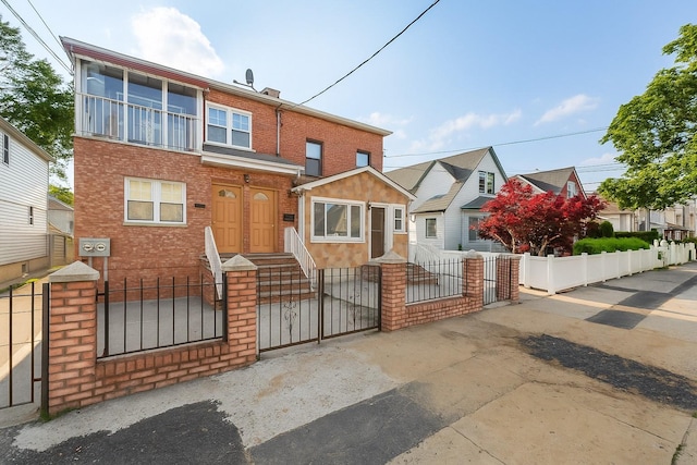 117-66 127th St, South Ozone Park, NY 11420 - view of front of property with a fenced front yard, a gate, and brick siding