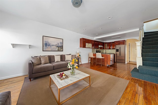 117-66 127th St, South Ozone Park, NY 11420 - living room with stairs, light wood-type flooring, arched walkways, and recessed lighting