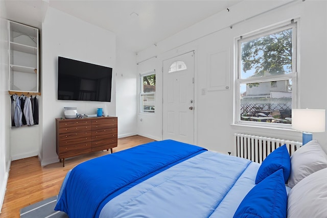117-66 127th St, South Ozone Park, NY 11420 - bedroom with radiator heating unit and wood finished floors