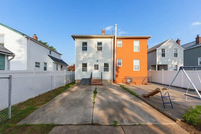 117-66 127th St, South Ozone Park, NY 11420 - rear view of property with a fenced backyard, a patio, entry steps, and a chimney