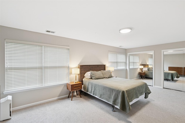 278 Pond View Ln, Smithtown, NY 11787 - carpeted bedroom featuring two closets and baseboards