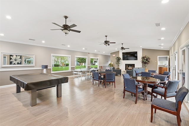 278 Pond View Ln, Smithtown, NY 11787 - rec room featuring light wood-style floors, ornamental molding, recessed lighting, a ceiling fan, and a large fireplace