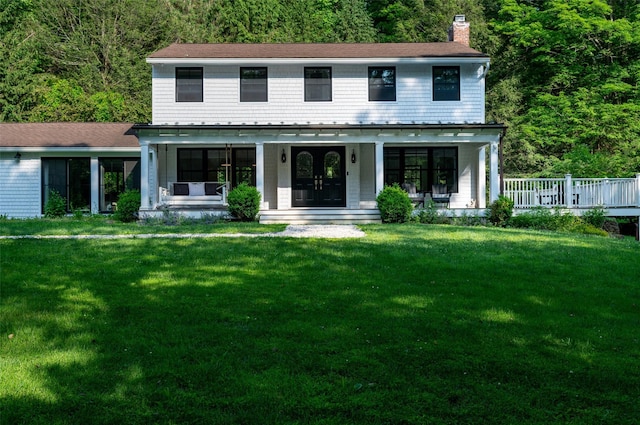 8 Maclean Dr, Pound Ridge, NY 10576 - view of front of house with a chimney, covered porch, a front yard, and a wooded view