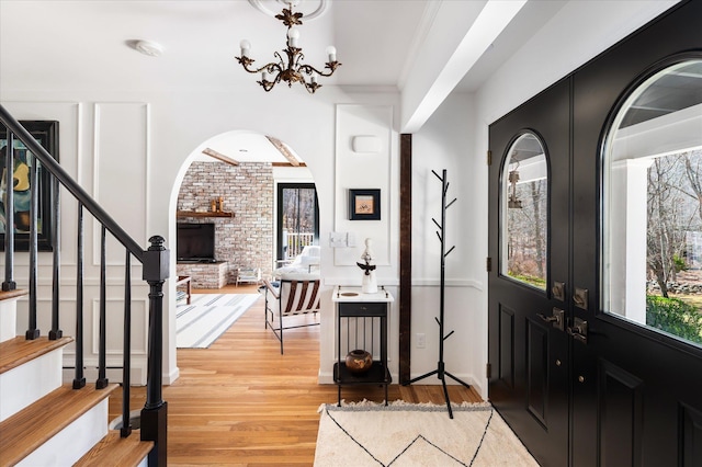 8 Maclean Dr, Pound Ridge, NY 10576 - foyer featuring arched walkways, light wood-style floors, stairway, and a chandelier