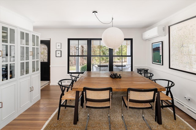 8 Maclean Dr, Pound Ridge, NY 10576 - dining area with a wall mounted air conditioner, ornamental molding, a baseboard heating unit, dark wood-style floors, and wainscoting