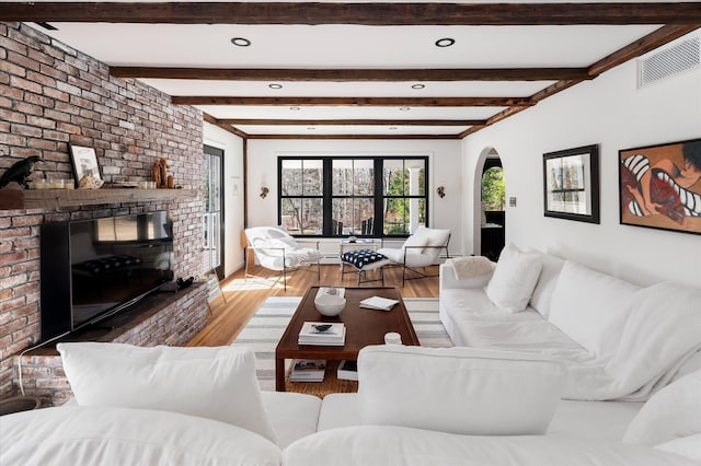 8 Maclean Dr, Pound Ridge, NY 10576 - living area featuring arched walkways, wood finished floors, a brick fireplace, recessed lighting, and beam ceiling