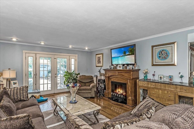 7 Woodstock Pl, Lake Grove, NY 11755 - living area featuring wood finished floors, a glass covered fireplace, ornamental molding, recessed lighting, and french doors
