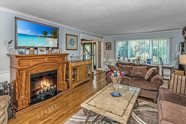 7 Woodstock Pl, Lake Grove, NY 11755 - living area with crown molding, wood finished floors, and a lit fireplace