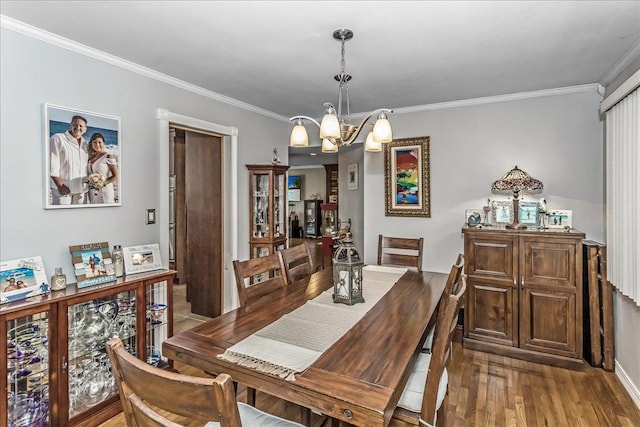 7 Woodstock Pl, Lake Grove, NY 11755 - dining area with a chandelier, ornamental molding, and wood finished floors