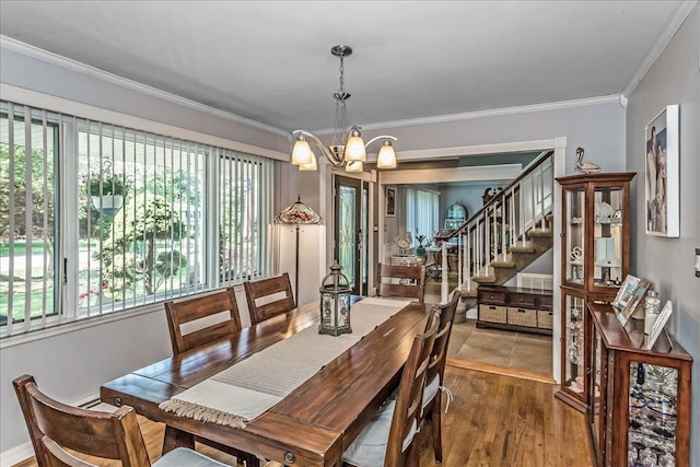 7 Woodstock Pl, Lake Grove, NY 11755 - dining space with a chandelier, crown molding, wood finished floors, and stairway