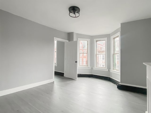 12 Liberty St, Newburgh, NY 12550 - spare room with wood finished floors and baseboards