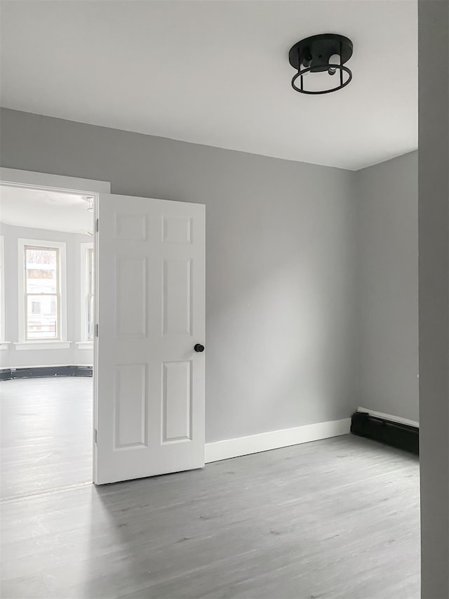 12 Liberty St, Newburgh, NY 12550 - spare room with wood finished floors and baseboards