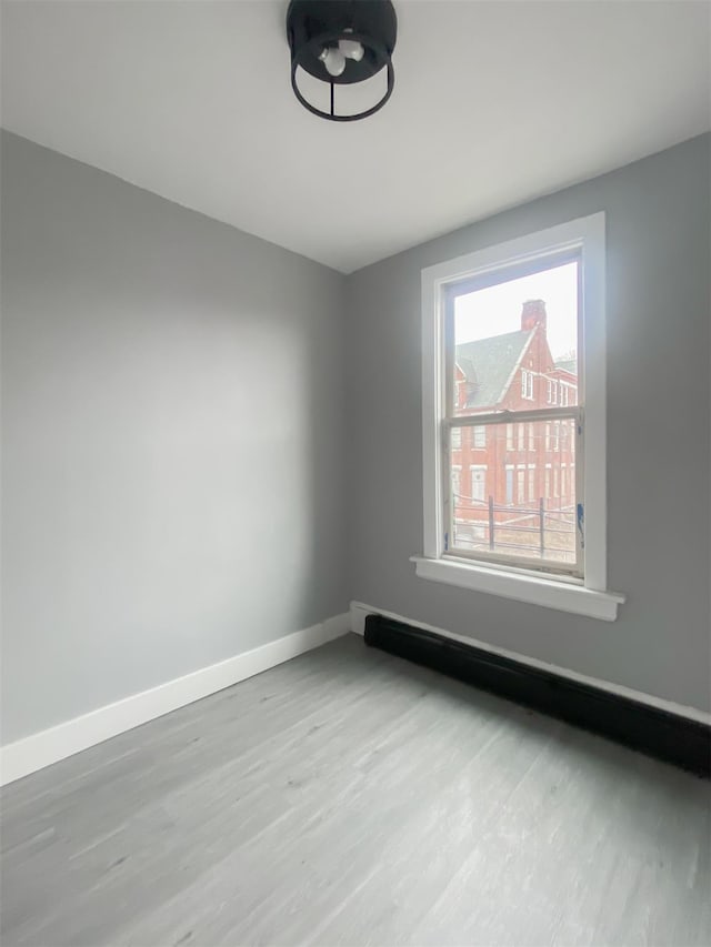 12 Liberty St, Newburgh, NY 12550 - empty room featuring wood finished floors and baseboards