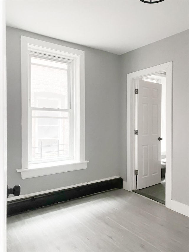 12 Liberty St, Newburgh, NY 12550 - empty room featuring plenty of natural light and wood finished floors