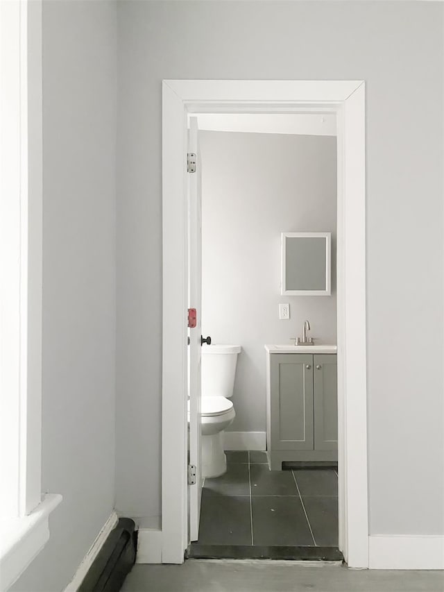 12 Liberty St, Newburgh, NY 12550 - bathroom with vanity, tile patterned flooring, and a baseboard heating unit