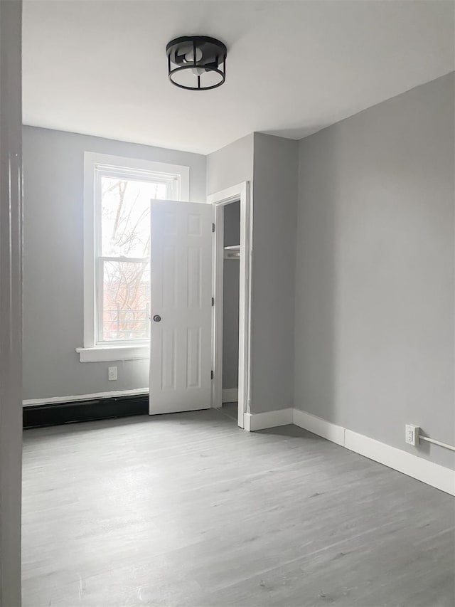 12 Liberty St, Newburgh, NY 12550 - unfurnished bedroom with wood finished floors and a closet