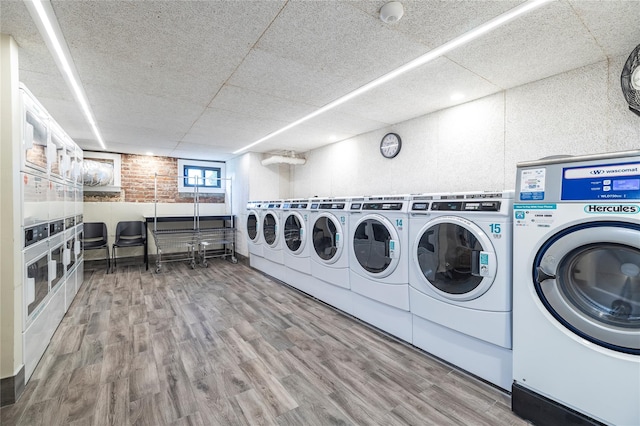 12 Hempstead Ave Unit 1G, Rockville Centre, NY 11570 - community laundry featuring stacked washing machine and dryer, independent washer and dryer, and wood finished floors