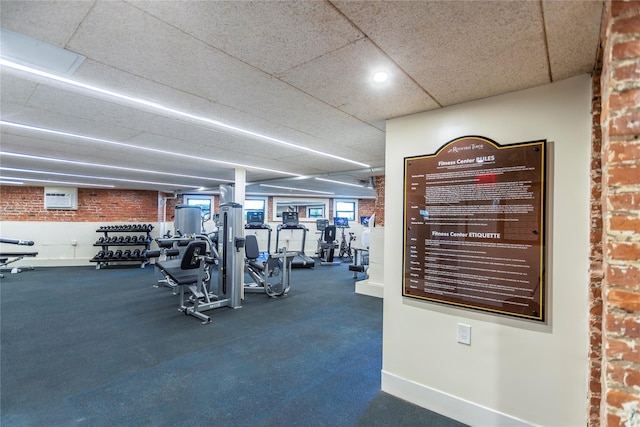 12 Hempstead Ave Unit 1G, Rockville Centre, NY 11570 - workout area featuring a wall unit AC, brick wall, and recessed lighting