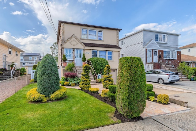 556 Long Beach Rd, Island Park, NY 11558 - traditional-style home with stucco siding and stairs