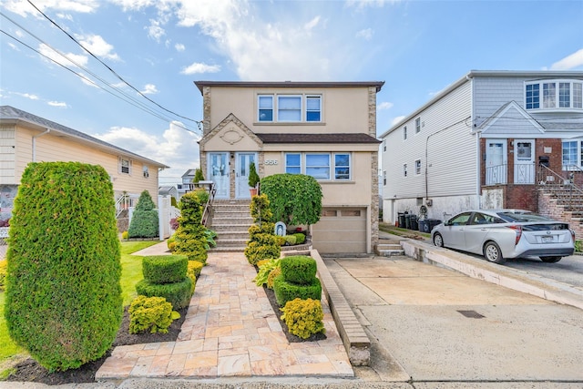 556 Long Beach Rd, Island Park, NY 11558 - traditional-style house with an attached garage, stucco siding, and concrete driveway