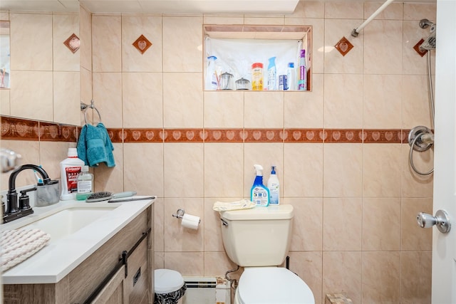 556 Long Beach Rd, Island Park, NY 11558 - bathroom featuring tile walls, vanity, a tile shower, and a baseboard heating unit