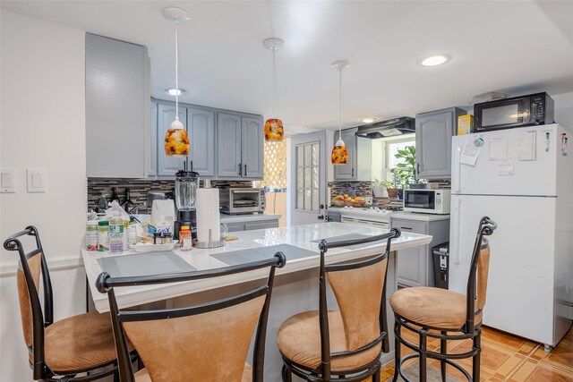 556 Long Beach Rd, Island Park, NY 11558 - kitchen with white appliances, gray cabinets, a peninsula, tasteful backsplash, and recessed lighting