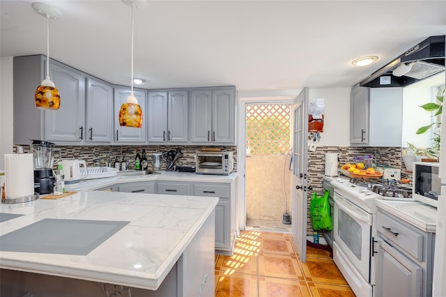556 Long Beach Rd, Island Park, NY 11558 - kitchen with white appliances, tasteful backsplash, gray cabinets, and decorative light fixtures