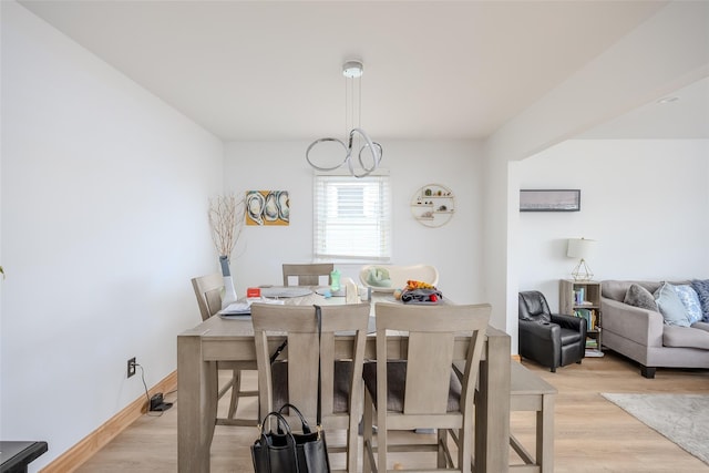 556 Long Beach Rd, Island Park, NY 11558 - dining space featuring light wood-style flooring and a chandelier