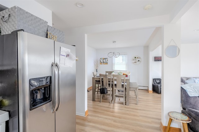 556 Long Beach Rd, Island Park, NY 11558 - kitchen with stainless steel refrigerator with ice dispenser, light wood finished floors, a baseboard radiator, and a chandelier