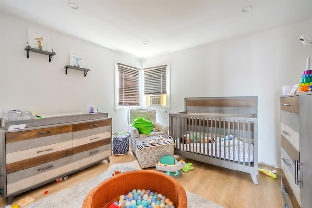 556 Long Beach Rd, Island Park, NY 11558 - bedroom with light wood finished floors and cooling unit
