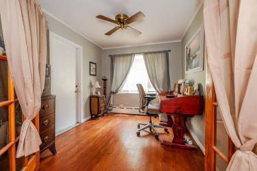 20 Wainwright St, Ronkonkoma, NY 11779 - office area with wood finished floors, ceiling fan, ornamental molding, and a baseboard radiator